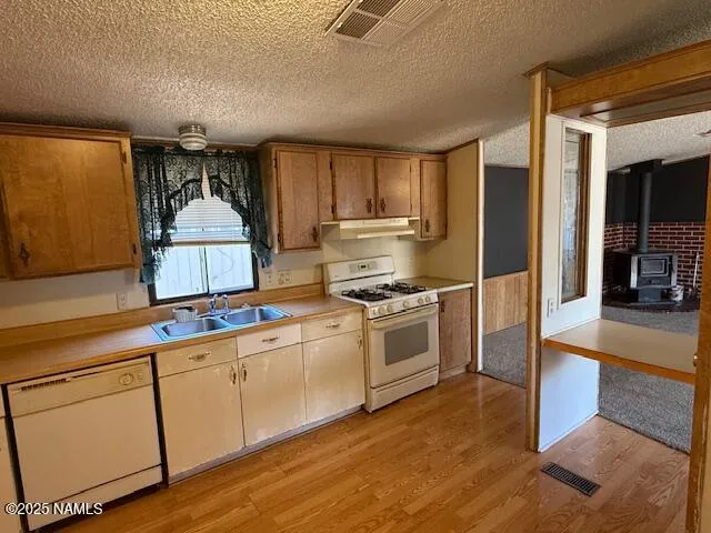 a kitchen with white cabinets and appliances