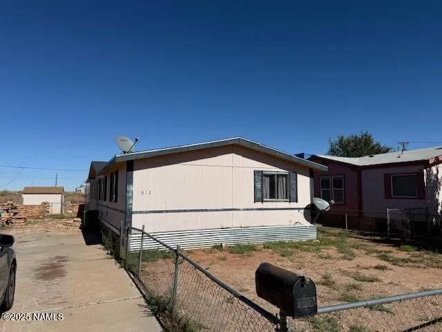 a view of a house with wooden fence