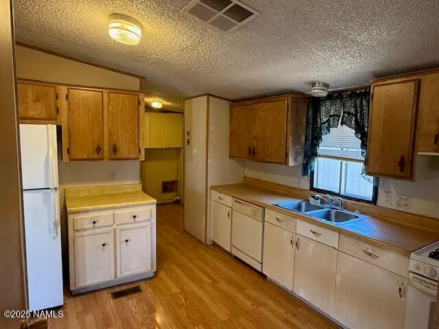 a kitchen with cabinets a sink and appliances