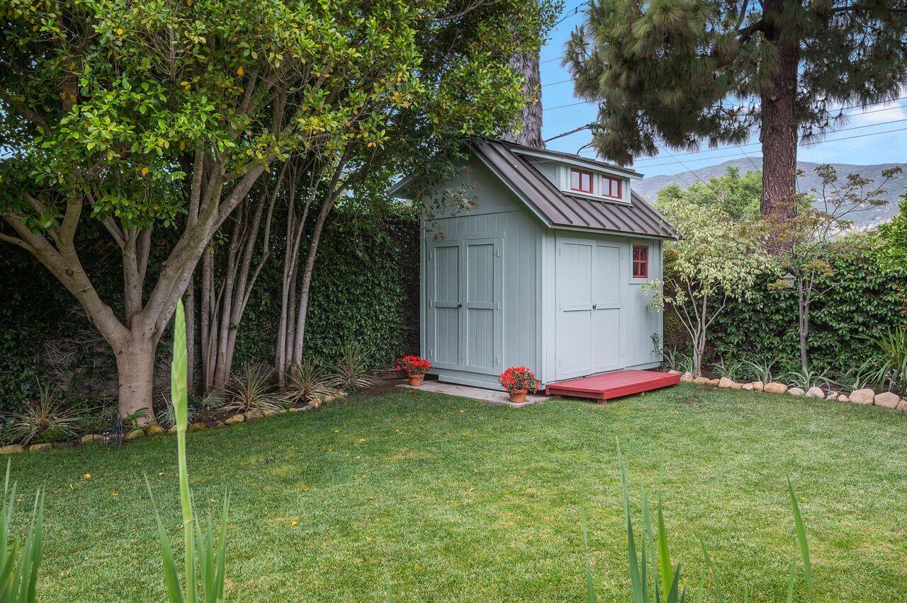 5118 Concord Place Carpinteria, CA 93013 - Photo 21 of 25 a view of a wooden house with a big yard and large trees
