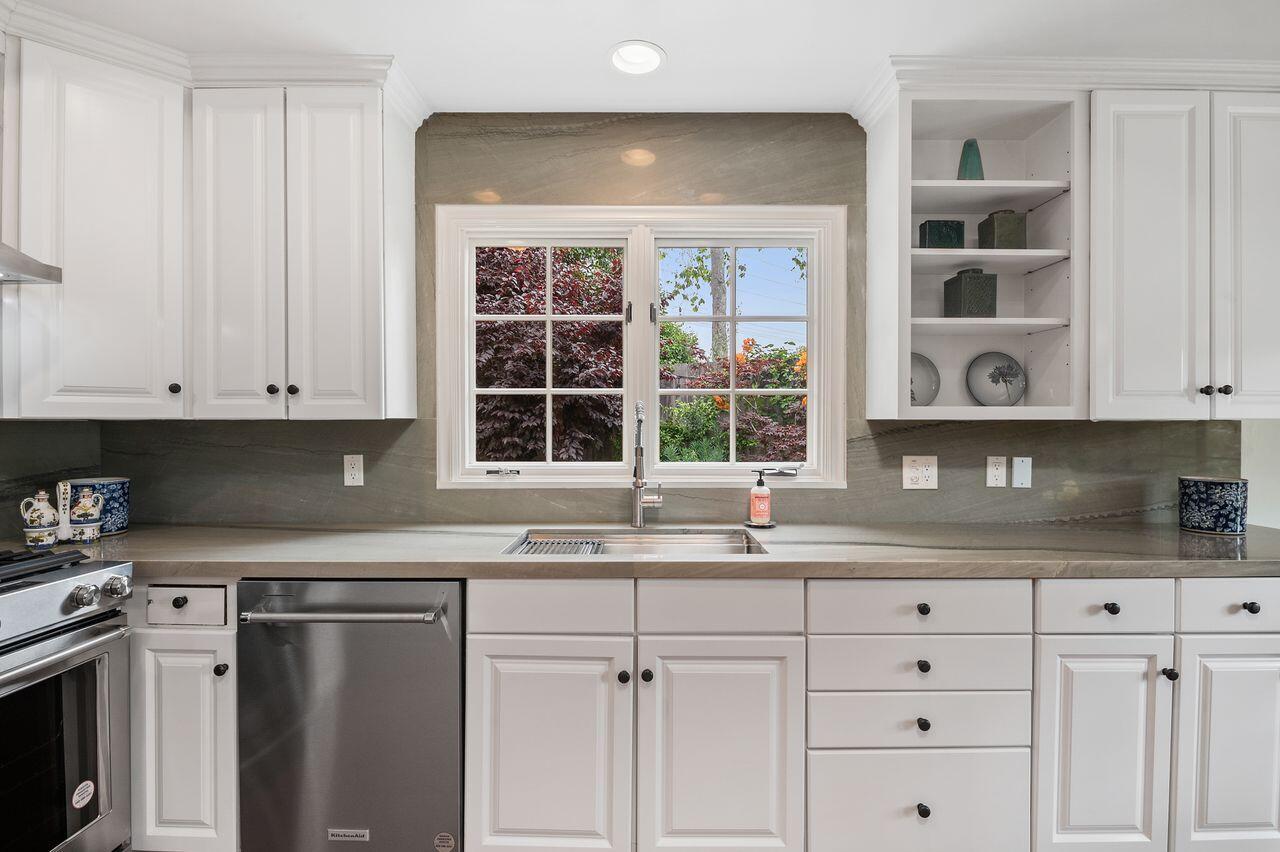 5118 Concord Place Carpinteria, CA 93013 - Photo 7 of 25 a kitchen with granite countertop white cabinets and window