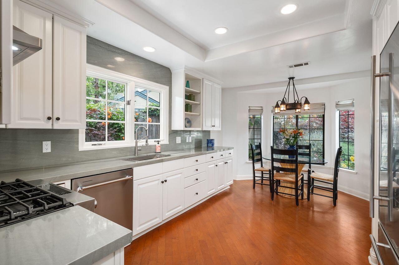 5118 Concord Place Carpinteria, CA 93013 - Photo 8 of 25 a kitchen with a table chairs stove and cabinets