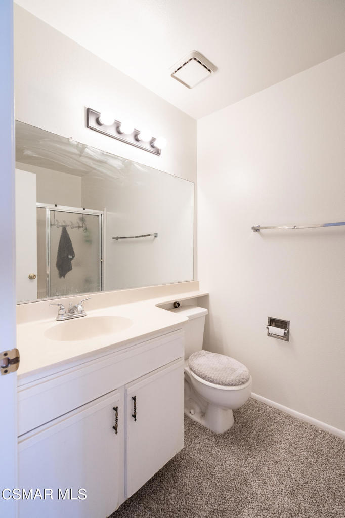 4240 Lost Hills Road, Unit 3302 Calabasas, CA 91301 - Photo 19 of 27 a bathroom with a toilet sink and mirror