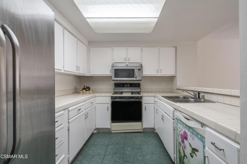 4240 Lost Hills Road, Unit 3302 Calabasas, CA 91301 - Photo 5 of 27 a kitchen with stainless steel appliances granite countertop a stove sink and cabinets