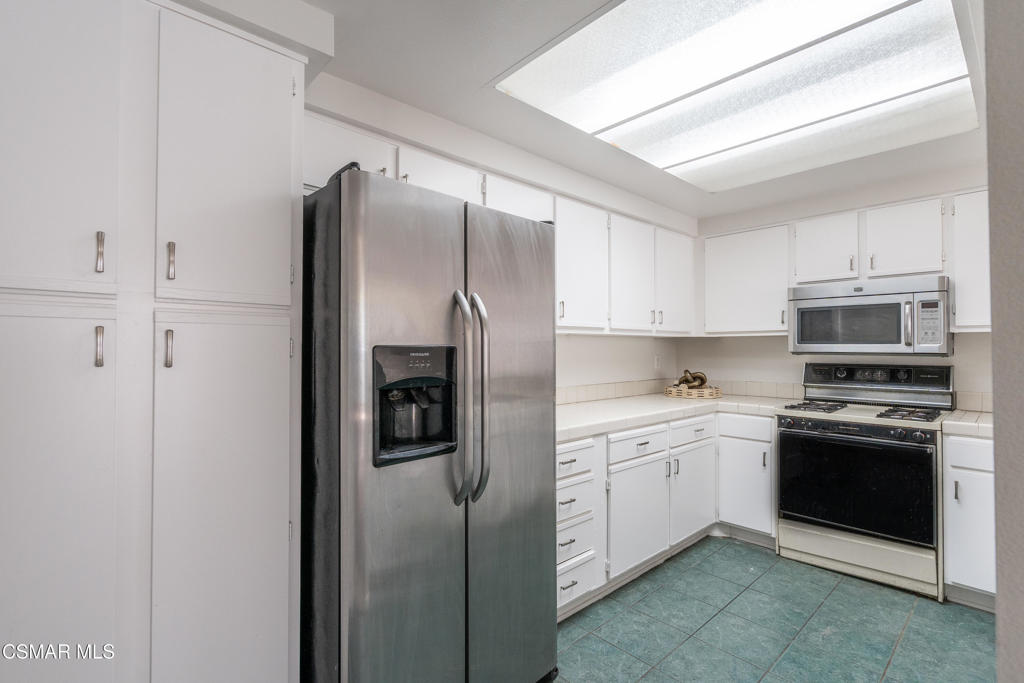 4240 Lost Hills Road, Unit 3302 Calabasas, CA 91301 - Photo 6 of 27 a kitchen with stainless steel appliances granite countertop a refrigerator and a stove top oven