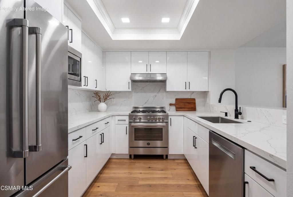 4240 Lost Hills Road, Unit 3302 Calabasas, CA 91301 - Photo 7 of 27 a kitchen with stainless steel appliances a stove sink and refrigerator