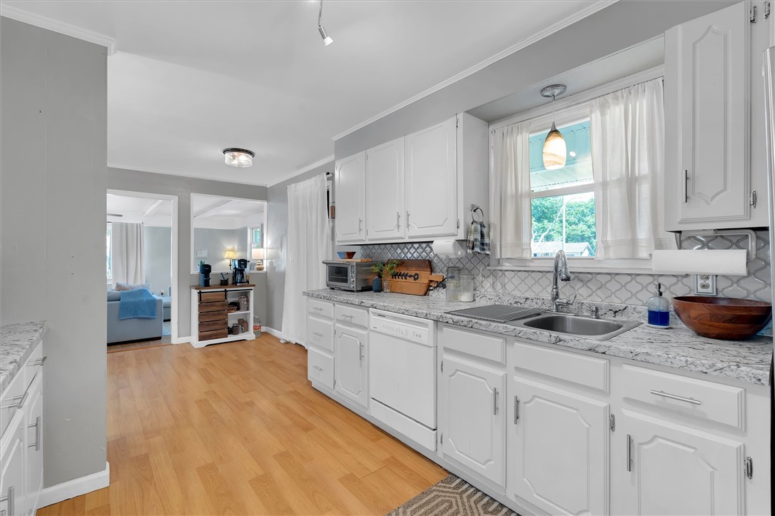 1815 Pearman Dairy Road Anderson, SC 29625 - Photo 7 of 35 A well-lit kitchen with classic white cabinetry and durable wood flooring.