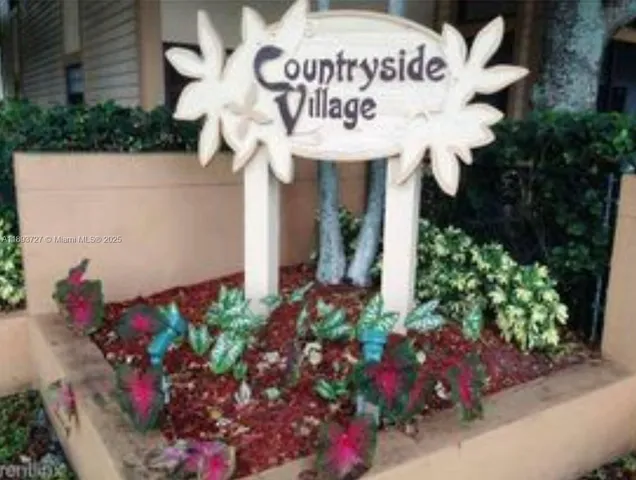 a sign that is sitting in front of flowers