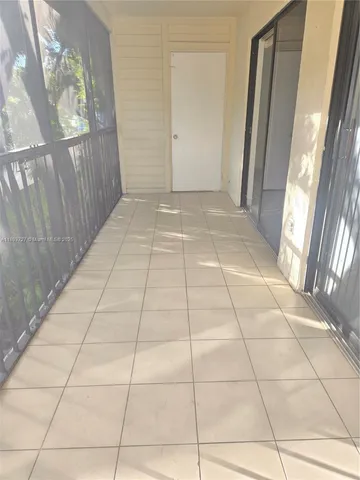 a view of a livingroom with wooden floor and a window