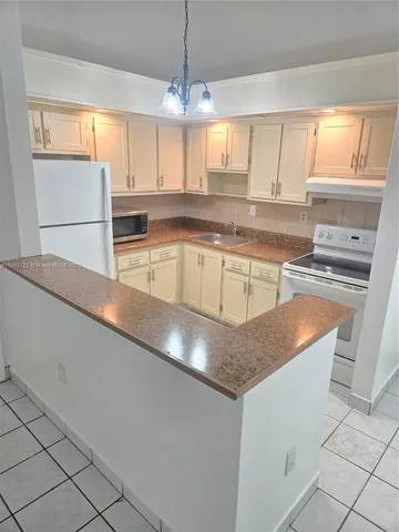 a kitchen with stainless steel appliances granite countertop a sink a stove and a microwave