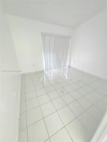 a view of an empty room and entryway