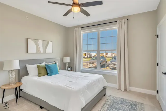 a bedroom with a large bed and a window