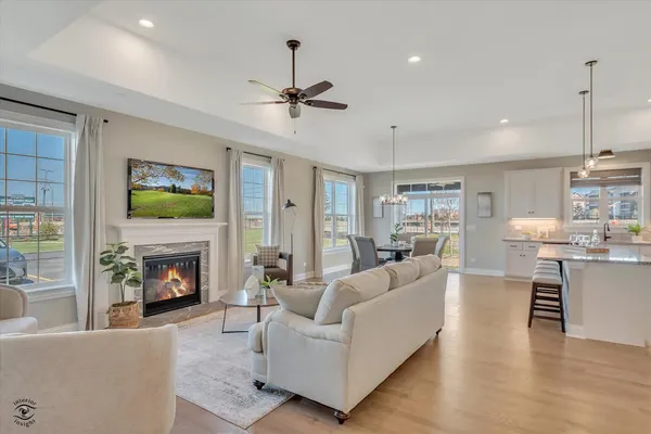 a living room with furniture a fireplace and a flat screen tv