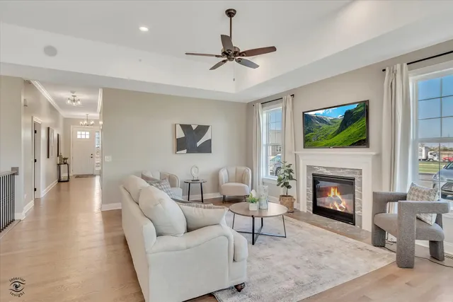 a living room with furniture a fireplace and a flat screen tv