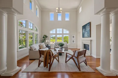 a living room with furniture fireplace and window