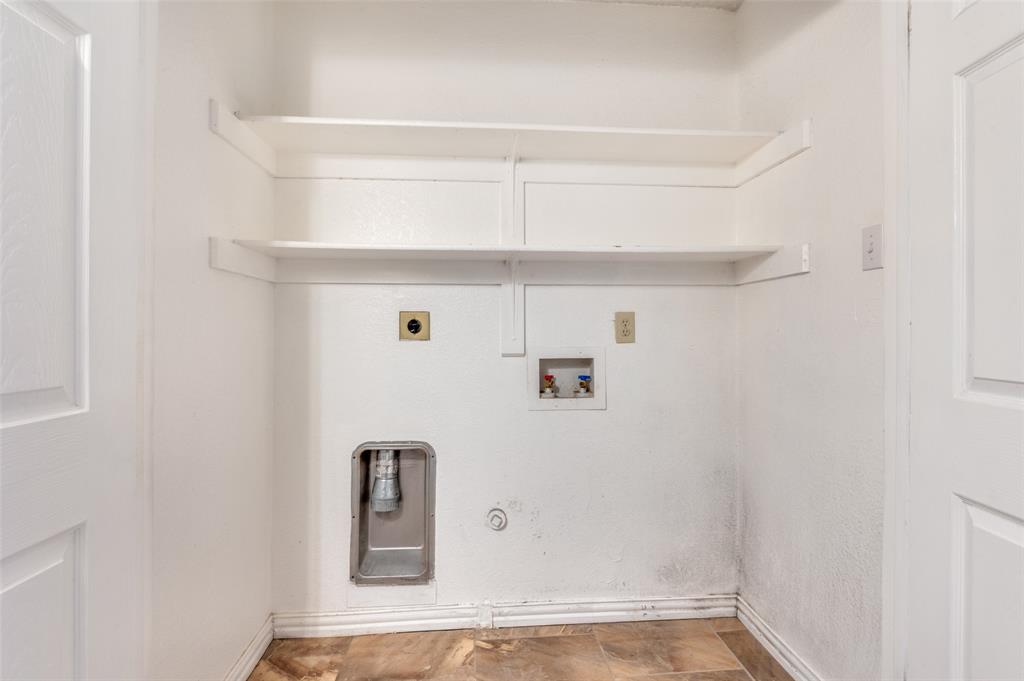 1300 Memory Lane, Unit 5214 Arlington, TX 76011 - Photo 16 of 30 The laundry is located in the hall behind the french doors. Shelves provide extra organization!