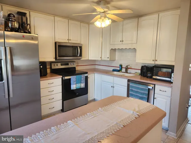 a kitchen with a refrigerator stove and microwave