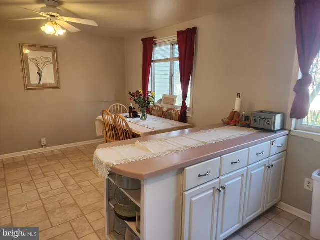 a bathroom with a granite countertop sink a toilet and mirror