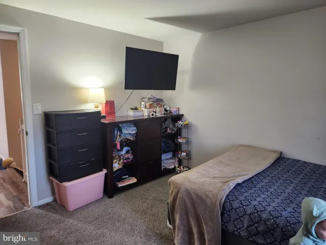 a bedroom with a bed and a flat tv screen