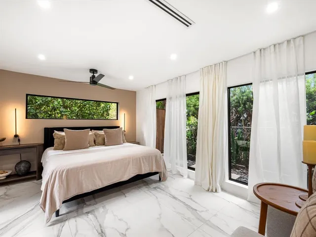 a bedroom with a large bed and a large window