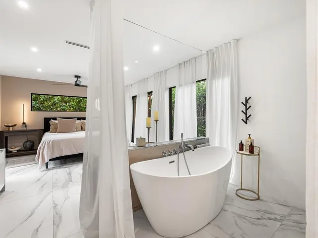 a spacious bathroom with a bathtub and a shower