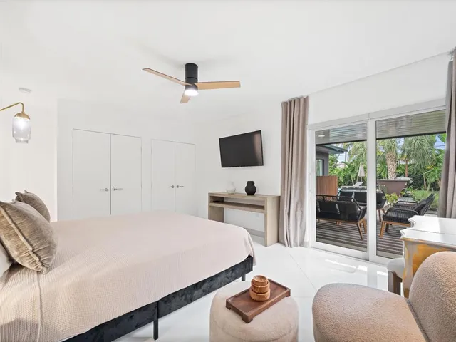 a bedroom with furniture and a flat screen tv