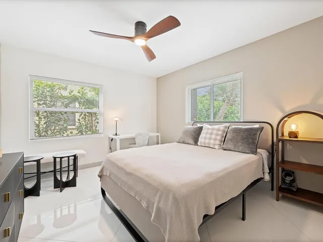 a bedroom with a large bed and a large window