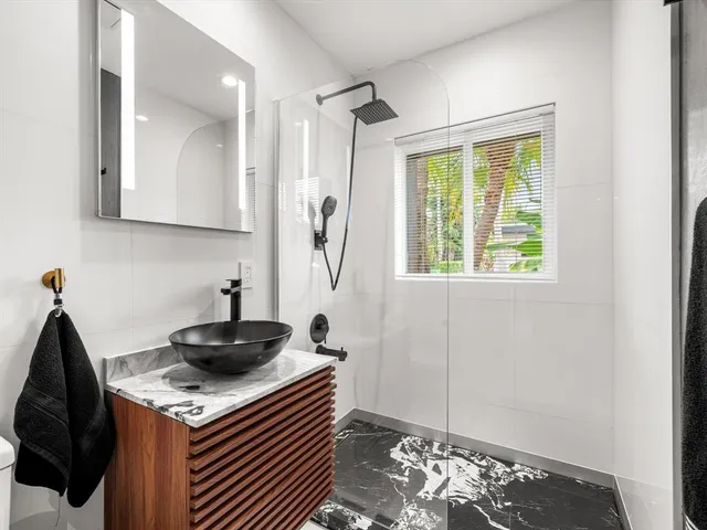 a kitchen with a stove and a wooden floor