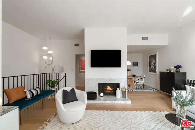 a bathroom with a granite countertop sink a toilet and a large mirror