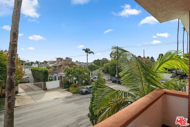 a kitchen with refrigerator cabinets and wooden floor