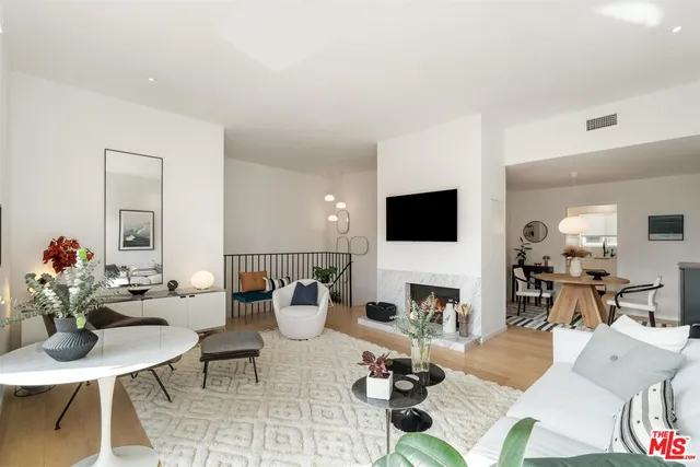 a bathroom with a granite countertop sink a toilet and a mirror
