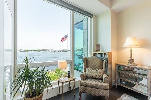 a living room with furniture and a floor to ceiling window