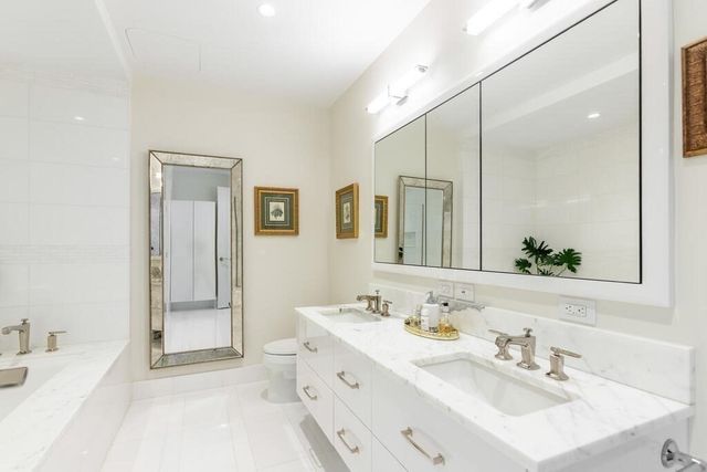 a bathroom with a sink double vanity and a mirror