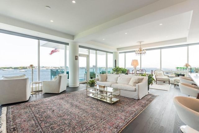 a living room with furniture and large windows