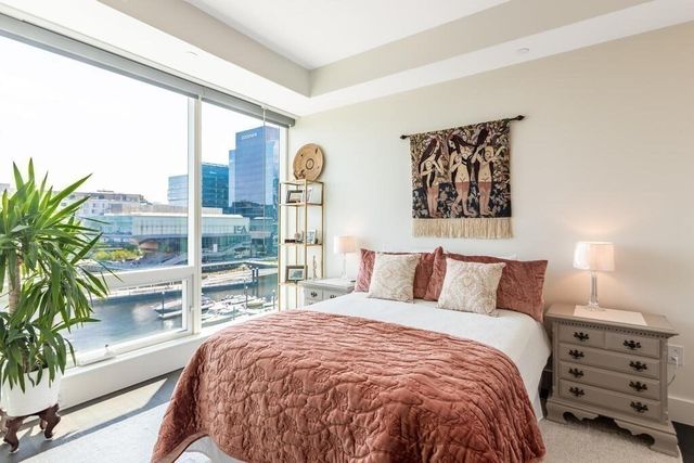 a bed sitting in a bedroom next to a window