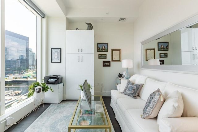 a living room with furniture and a floor to ceiling window
