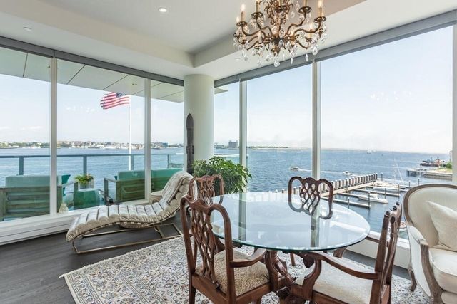 a dining room with furniture water view and wooden floor