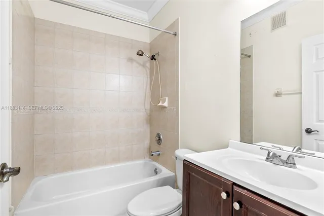 a bathroom with a sink toilet tub and shower