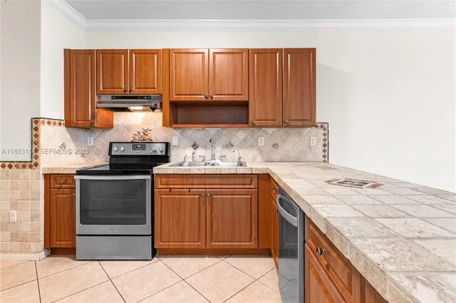 a kitchen with kitchen island granite countertop wooden cabinets and white appliances