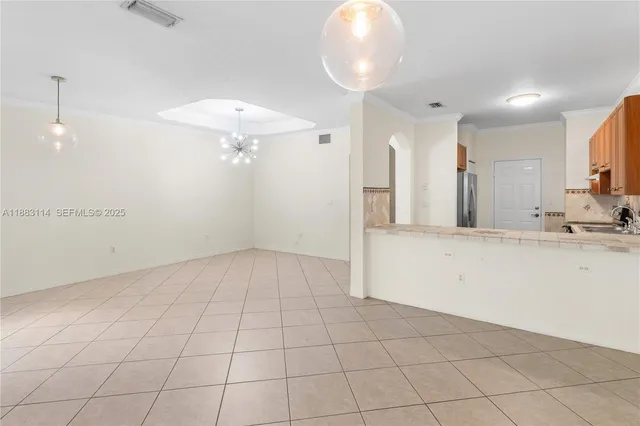 a view of a kitchen with a sink and chandelier
