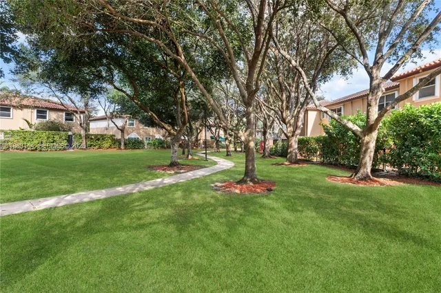 a view of a tree in front of a house