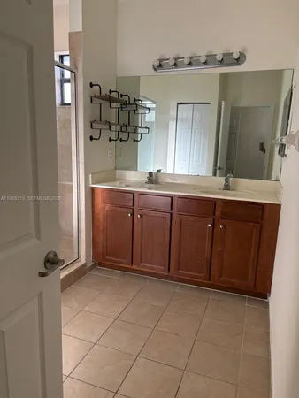 a bathroom with a sink and mirror