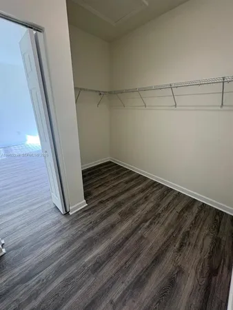 a view of a room with wooden floor