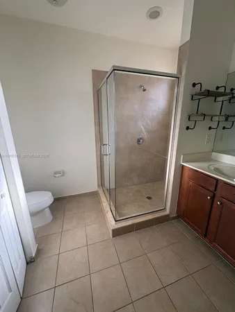 a bathroom with a glass shower door