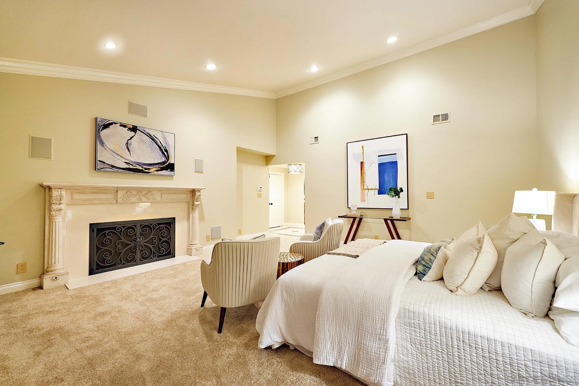 2027 Alga Road Carlsbad, CA 92009 - Photo 32 of 72 a spacious bedroom with a bed and a fireplace