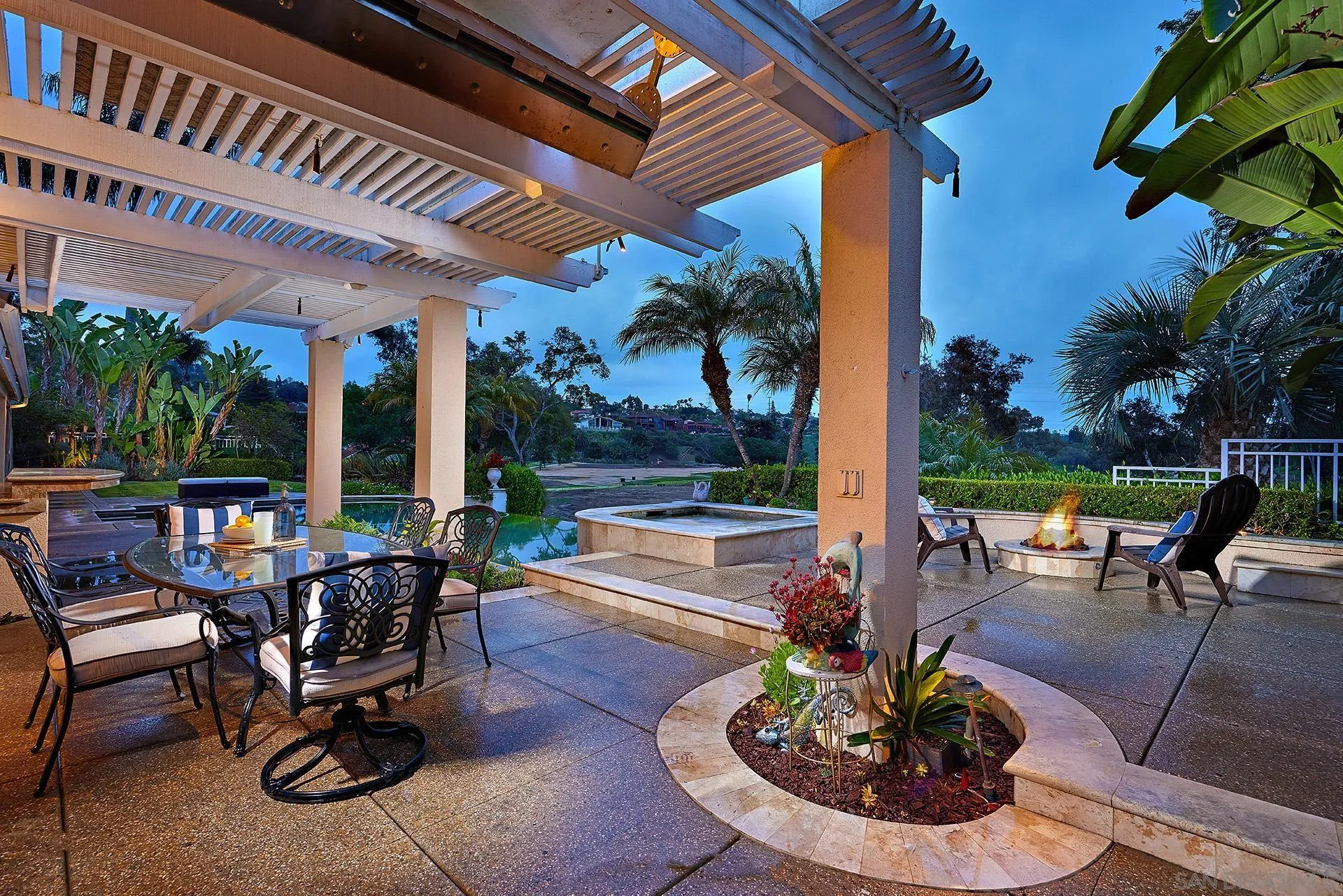 2027 Alga Road Carlsbad, CA 92009 - Photo 4 of 72 a view of a patio with table and chairs potted plants and palm tree