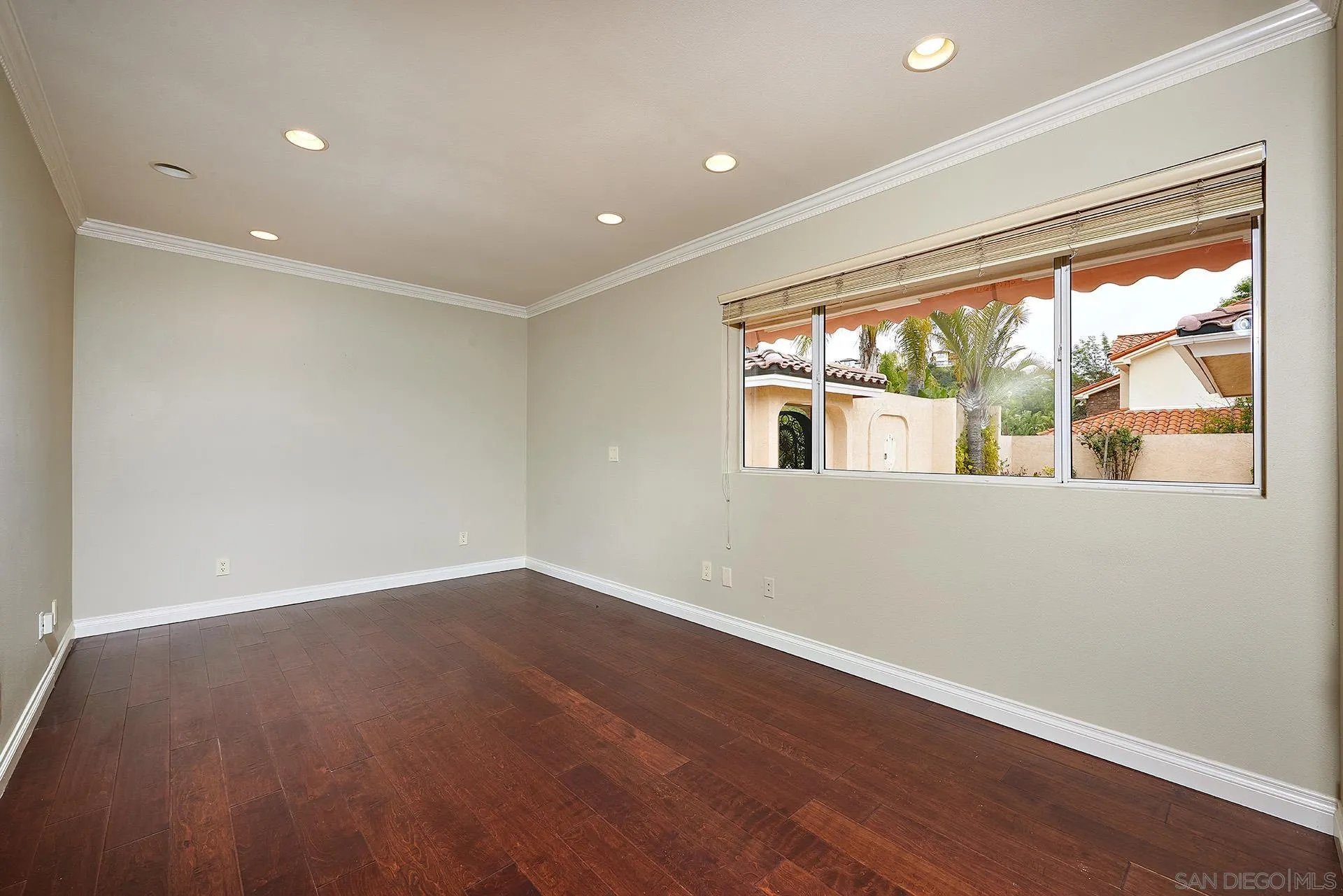 2027 Alga Road Carlsbad, CA 92009 - Photo 41 of 72 an empty room with wooden floor and windows