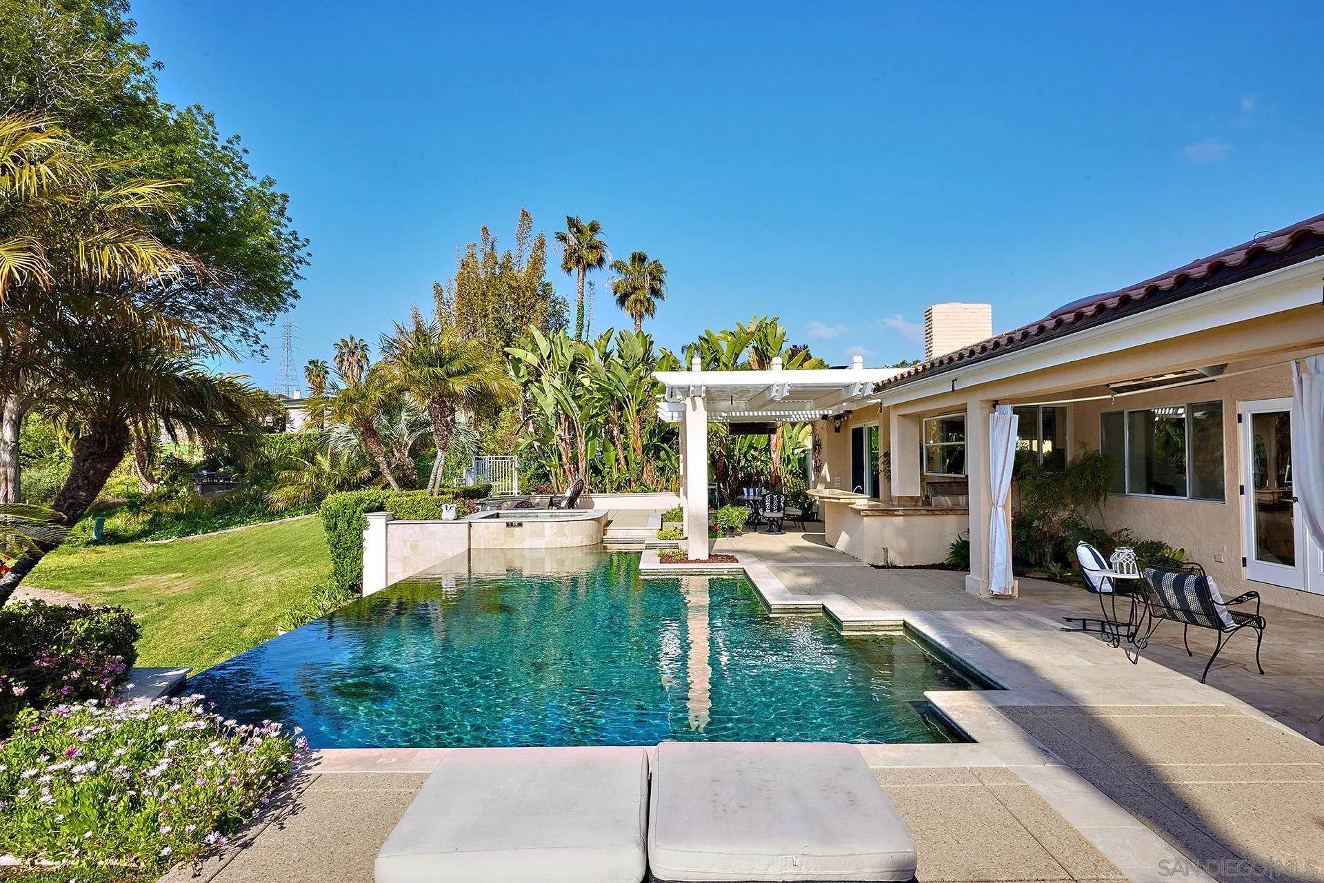 2027 Alga Road Carlsbad, CA 92009 - Photo 53 of 72 a view of a house with backyard sitting area and garden