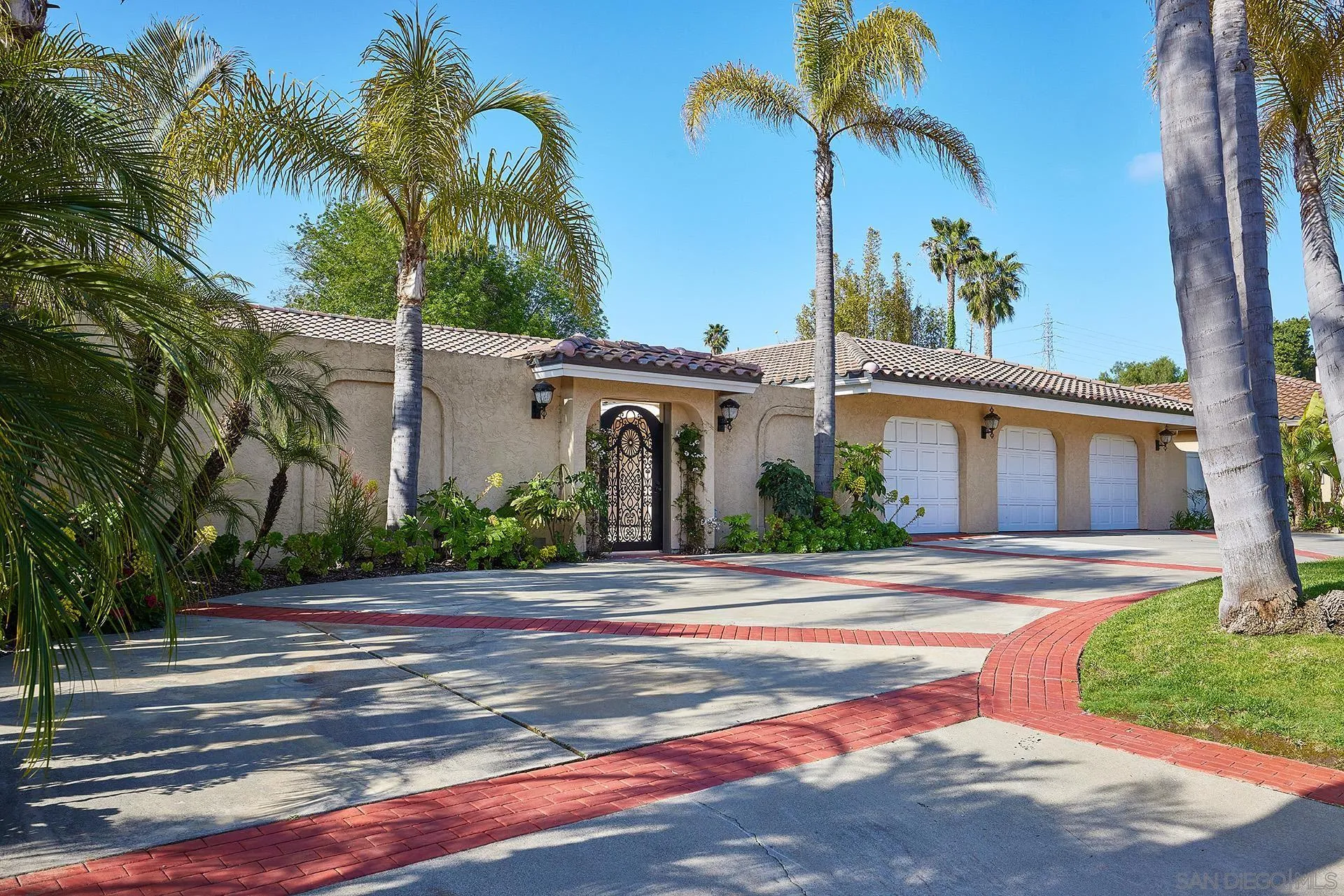 2027 Alga Road Carlsbad, CA 92009 - Photo 56 of 72 a front view of a house with a garden