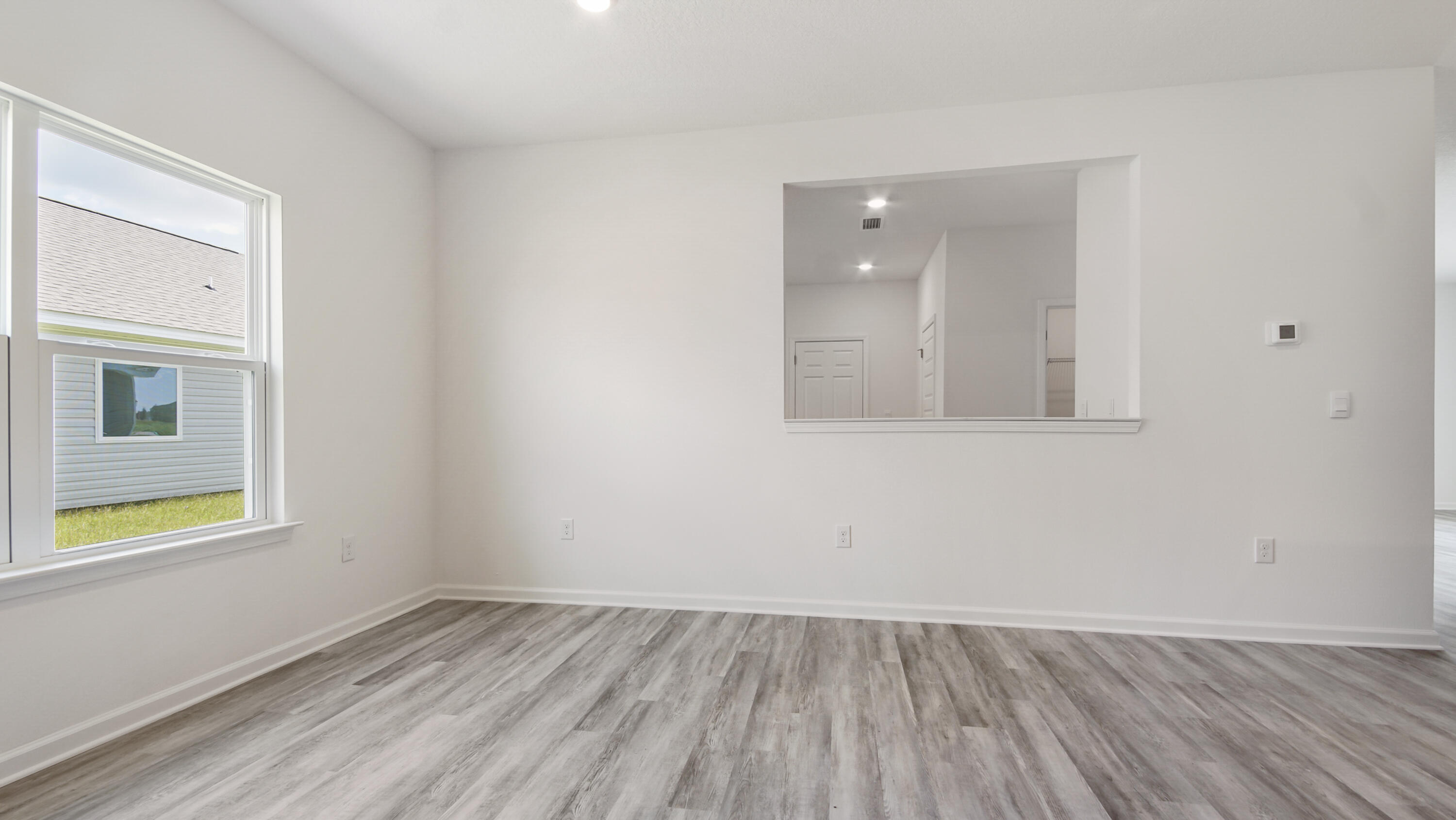 494 Arrowwood Boulevard Freeport, FL 32439 - Photo 6 of 32 an empty room with wooden floor and windows